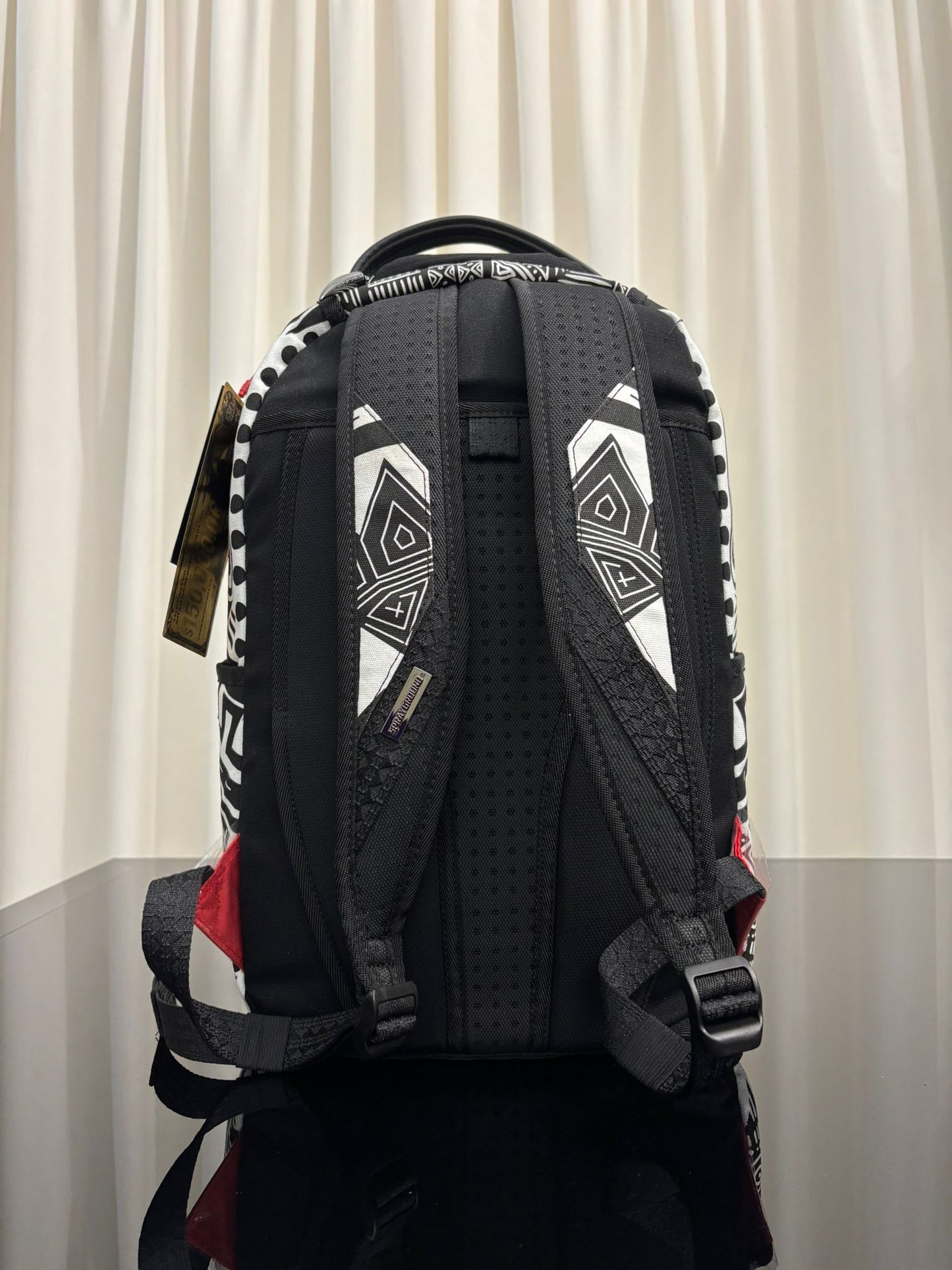 AI WONDERLAND GOLD AND BLACK BACKPACK SPRAYGROUND